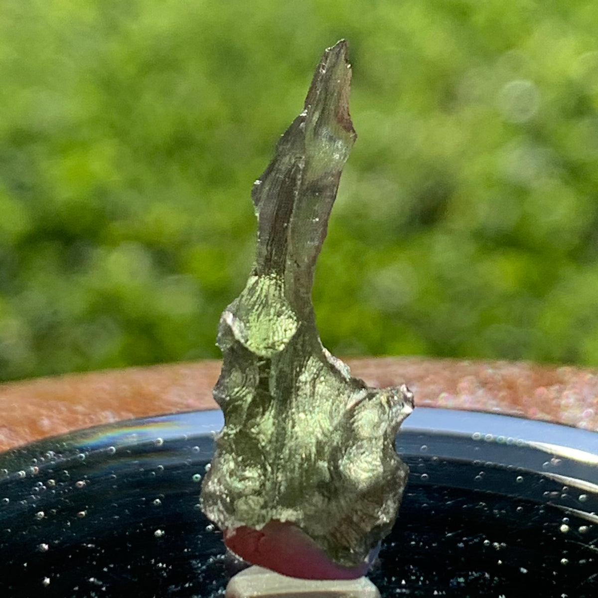 thin green besednice moldavite tektite on display