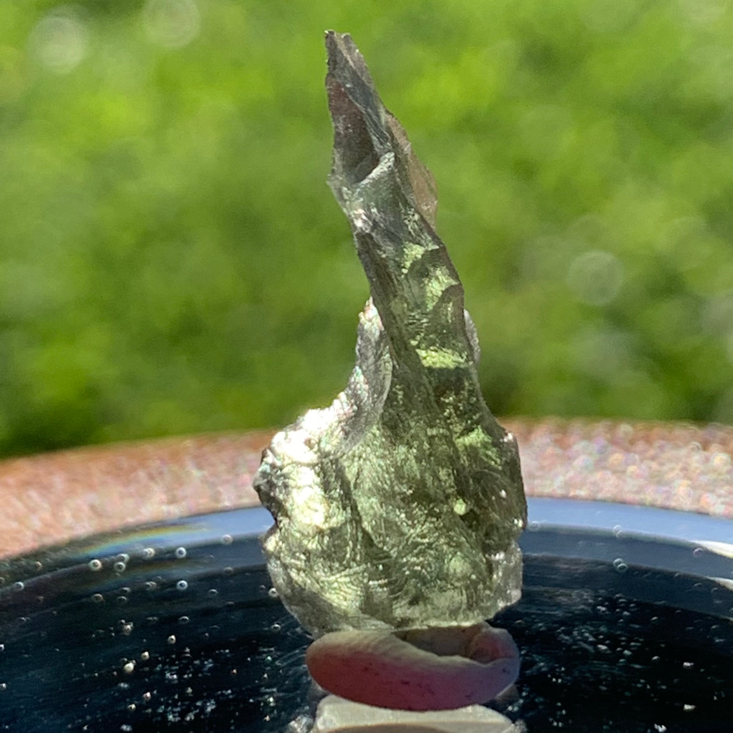 thin green besednice moldavite tektite on display