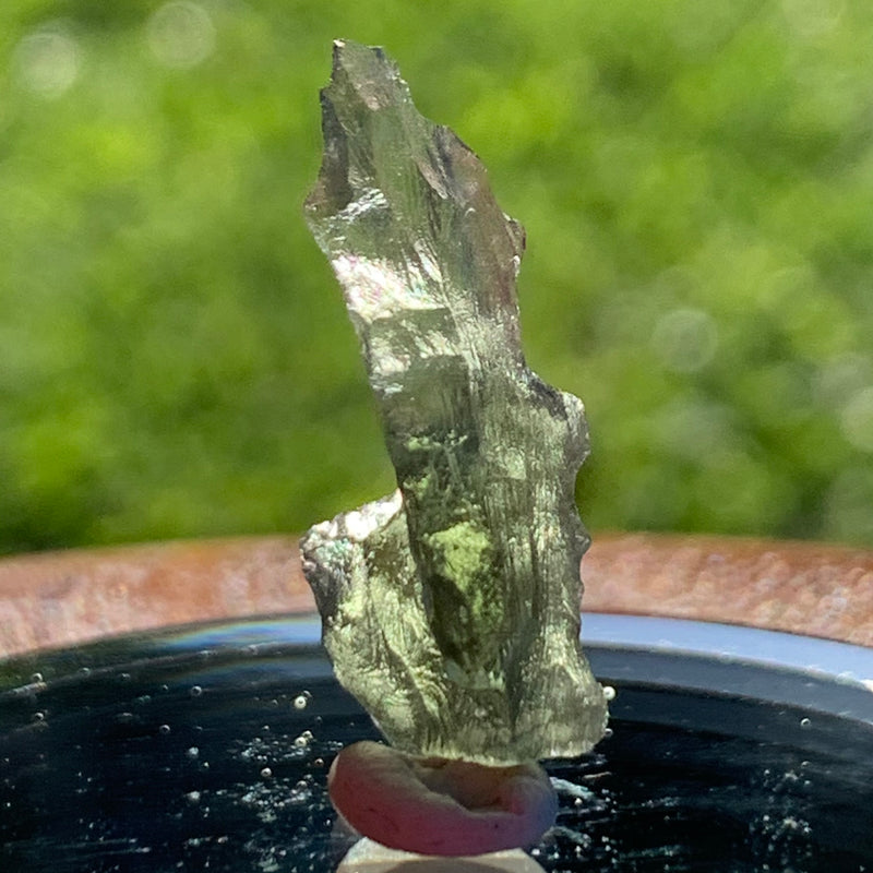 thin green besednice moldavite tektite on display