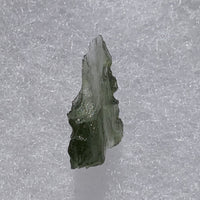 thin green besednice moldavite tektite on display