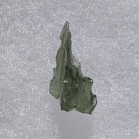 thin green besednice moldavite tektite on display