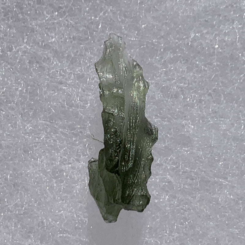 thin green besednice moldavite tektite on display