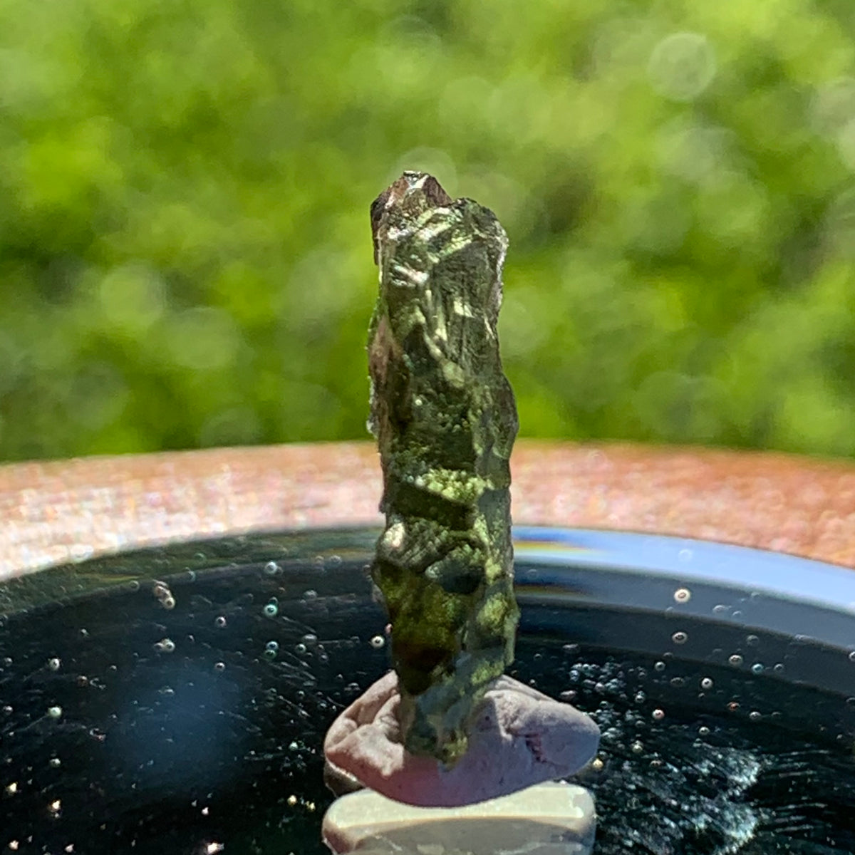 thin green besednice moldavite tektite on display