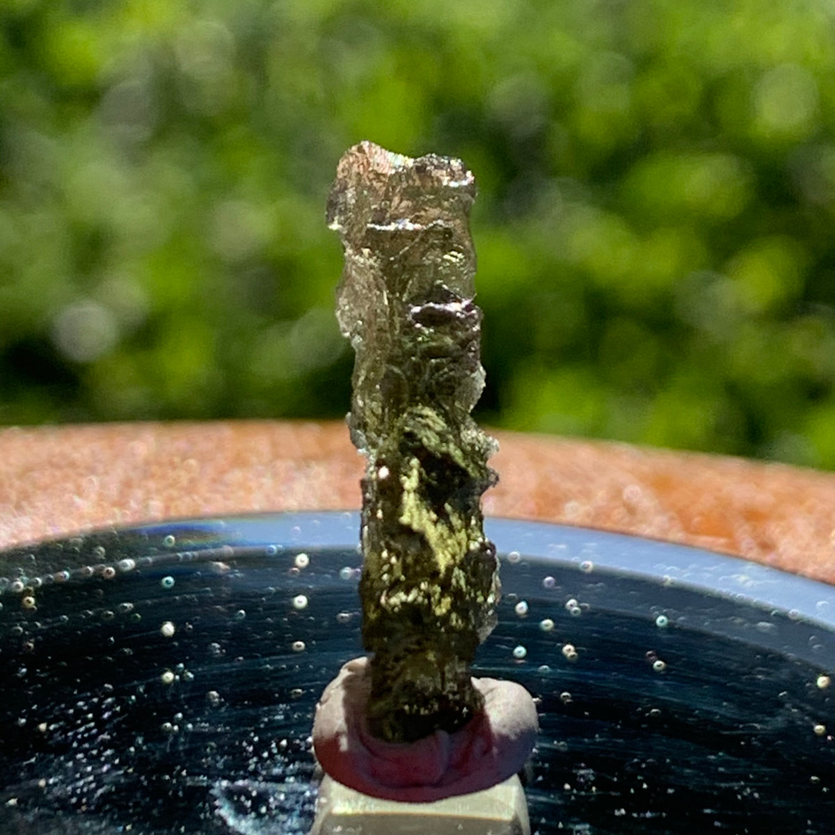 thin green besednice moldavite tektite on display