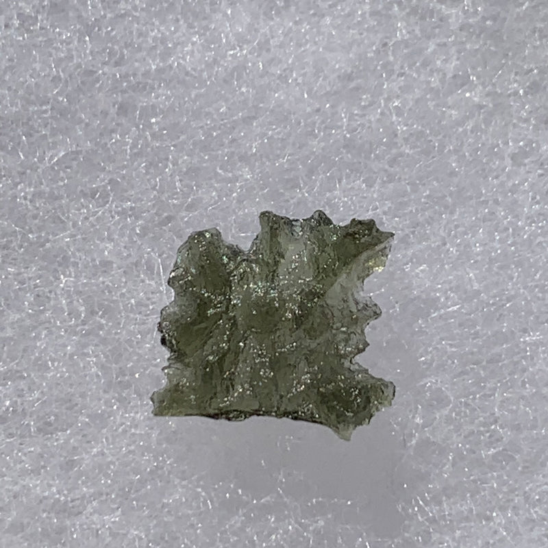 thin green besednice moldavite tektite on display