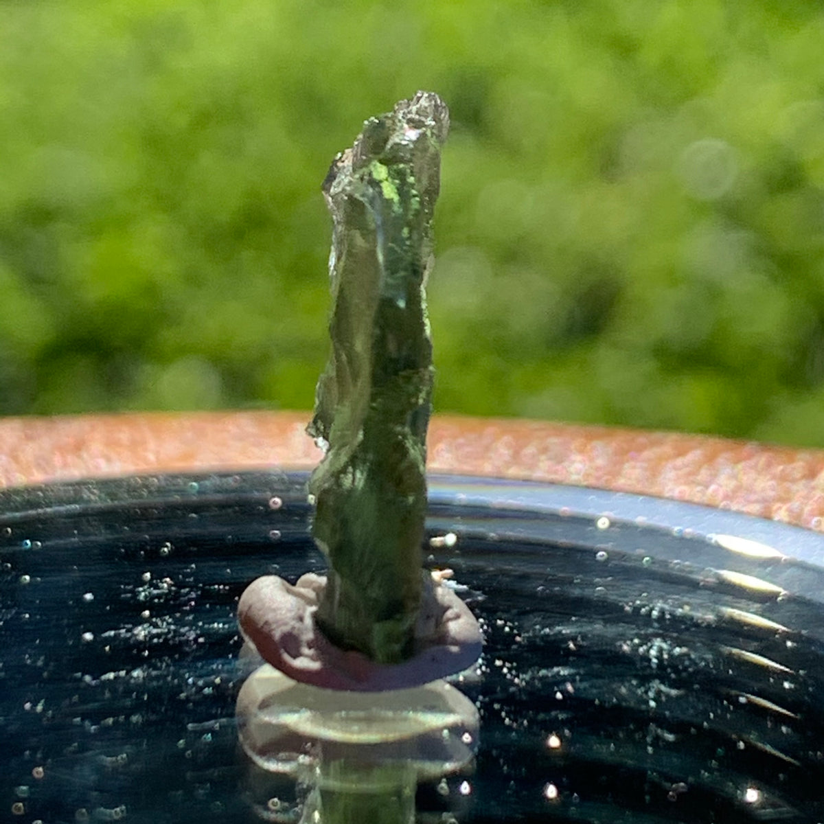 thin green besednice moldavite tektite on display