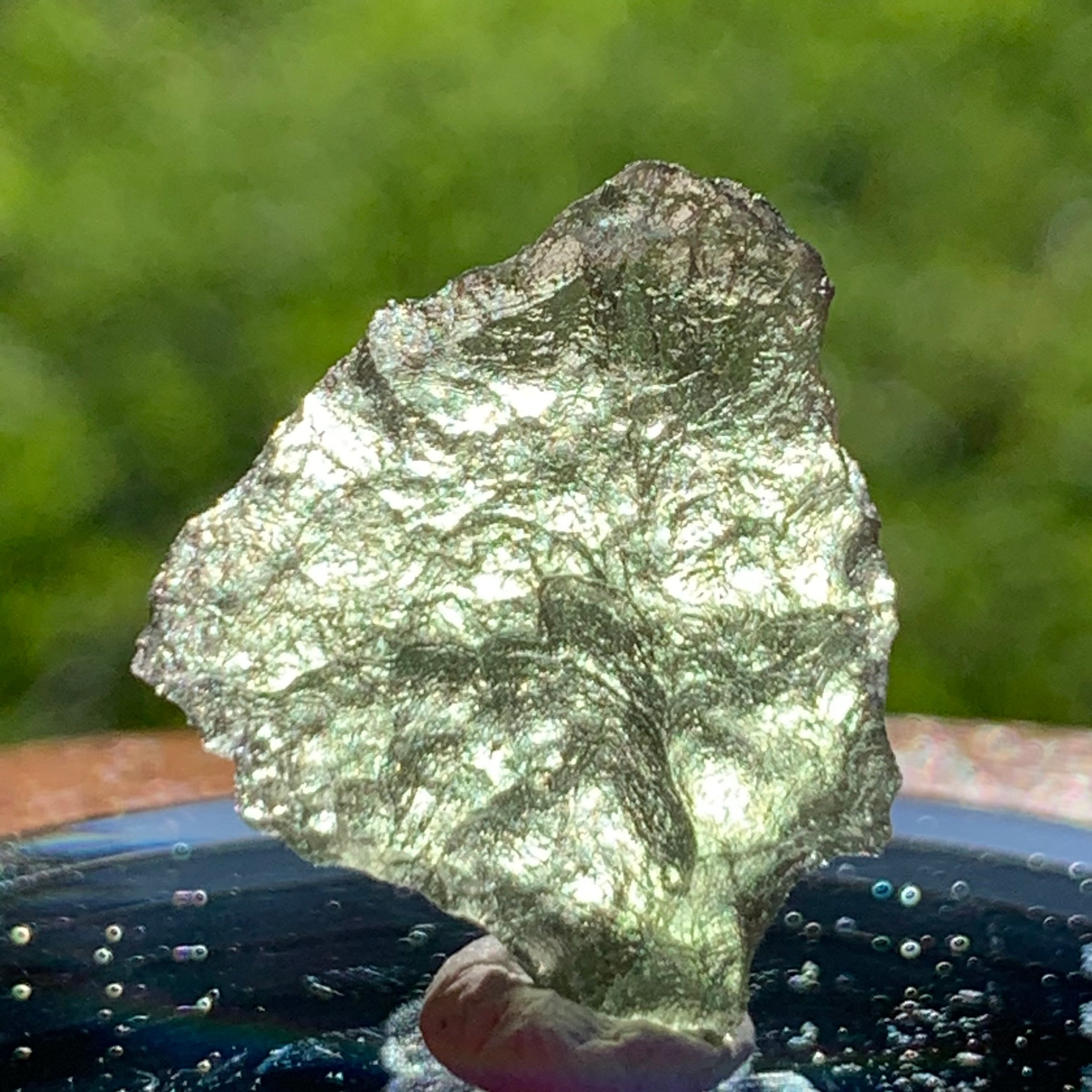 thin green besednice moldavite tektite on display