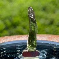 thin green besednice moldavite tektite on display