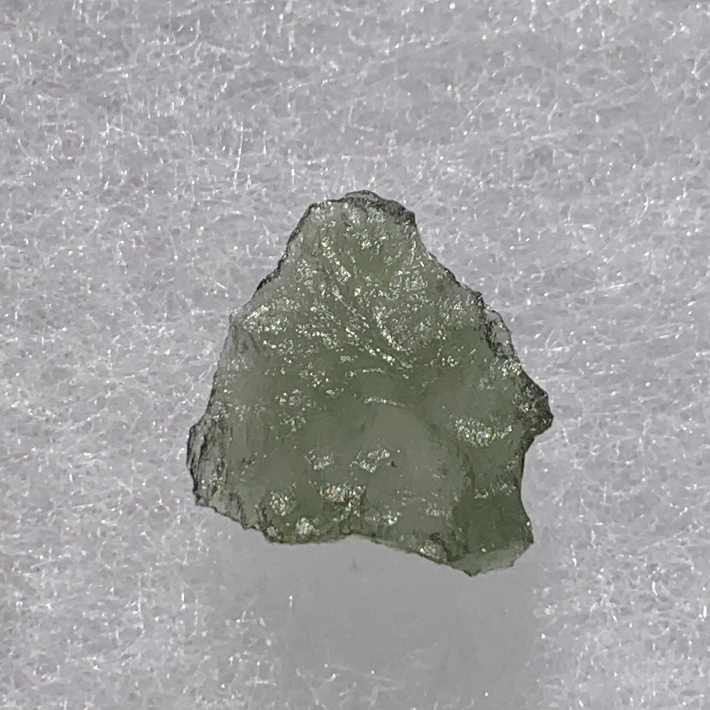 thin green besednice moldavite tektite on display