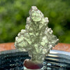 thin green besednice moldavite tektite on display