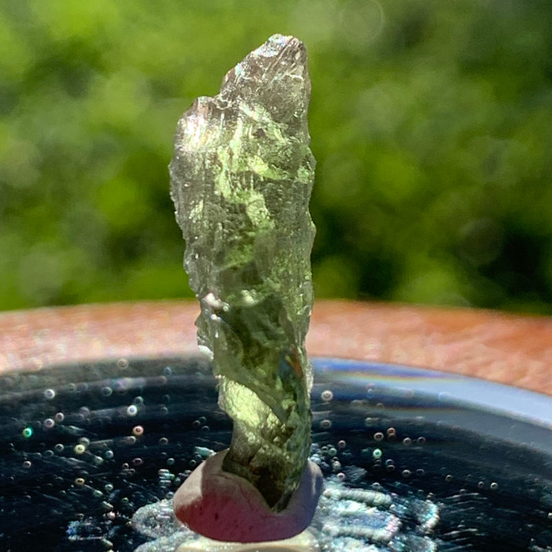 thin green besednice moldavite tektite on display