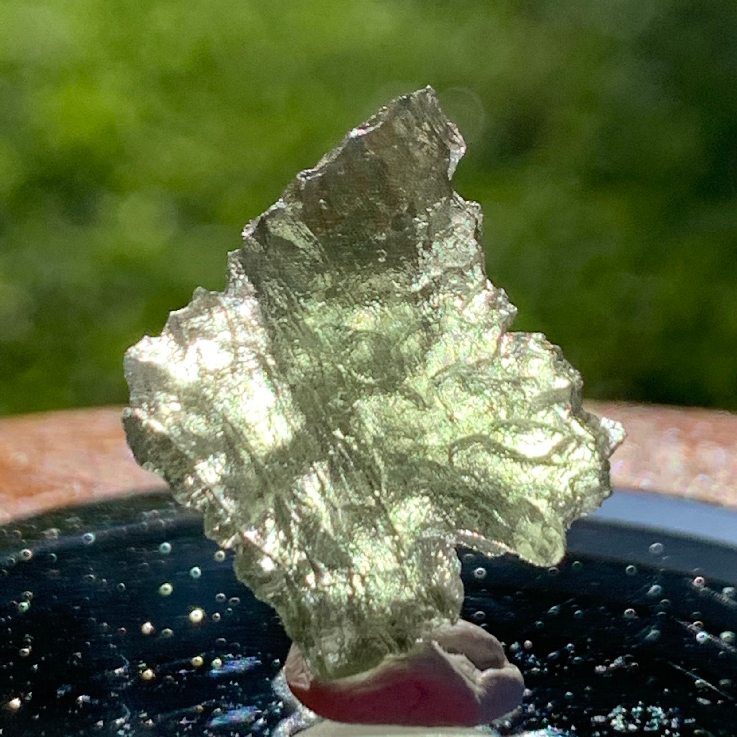 thin green besednice moldavite tektite on display