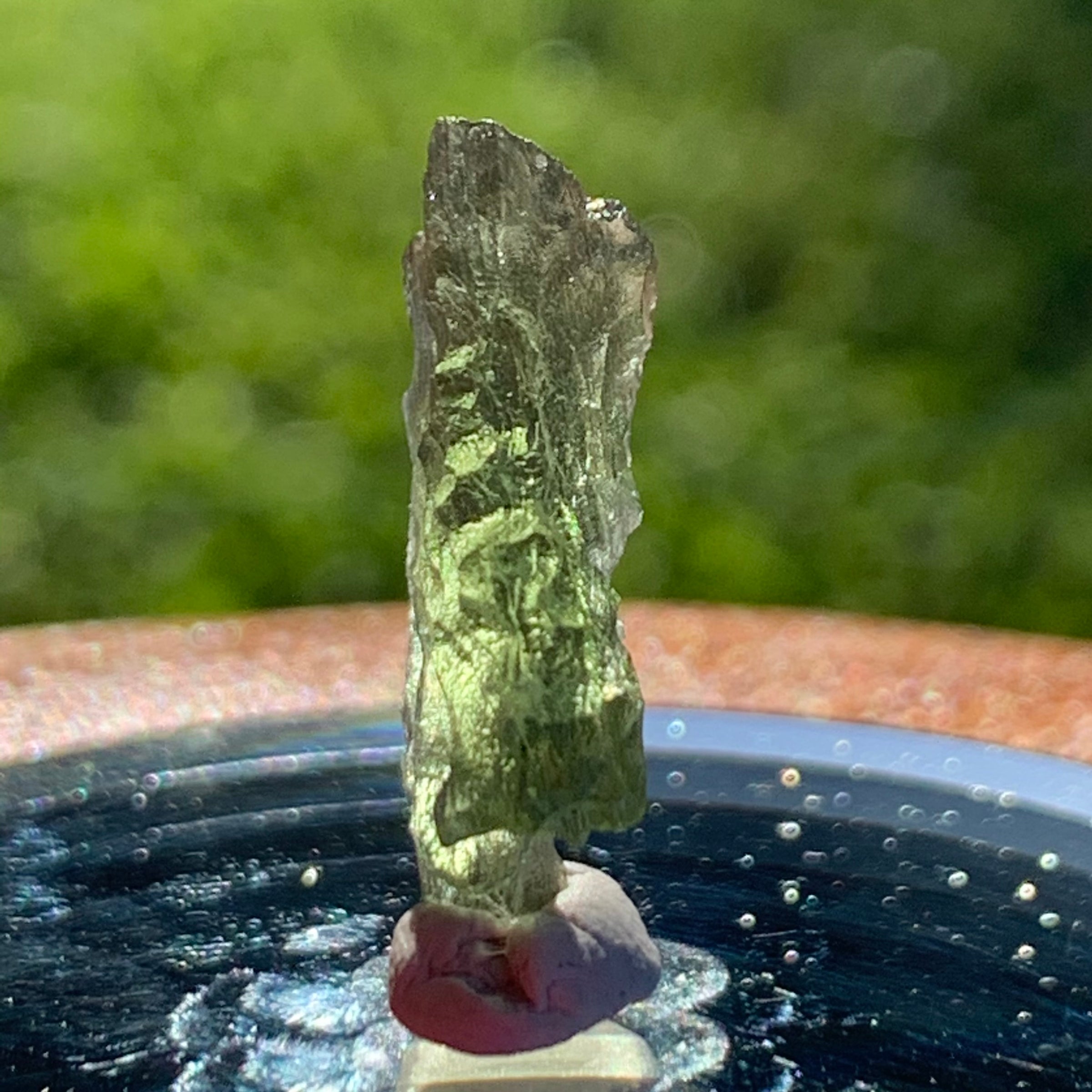 thin green besednice moldavite tektite on display