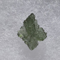 thin green besednice moldavite tektite on display