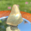 light reflects a rainbow through the libyan desert glass on display