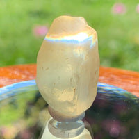 light reflects a rainbow through the libyan desert glass on display