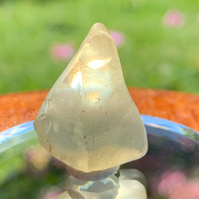 light reflects a rainbow through the libyan desert glass on display