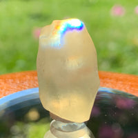 light reflects a rainbow through the libyan desert glass on display