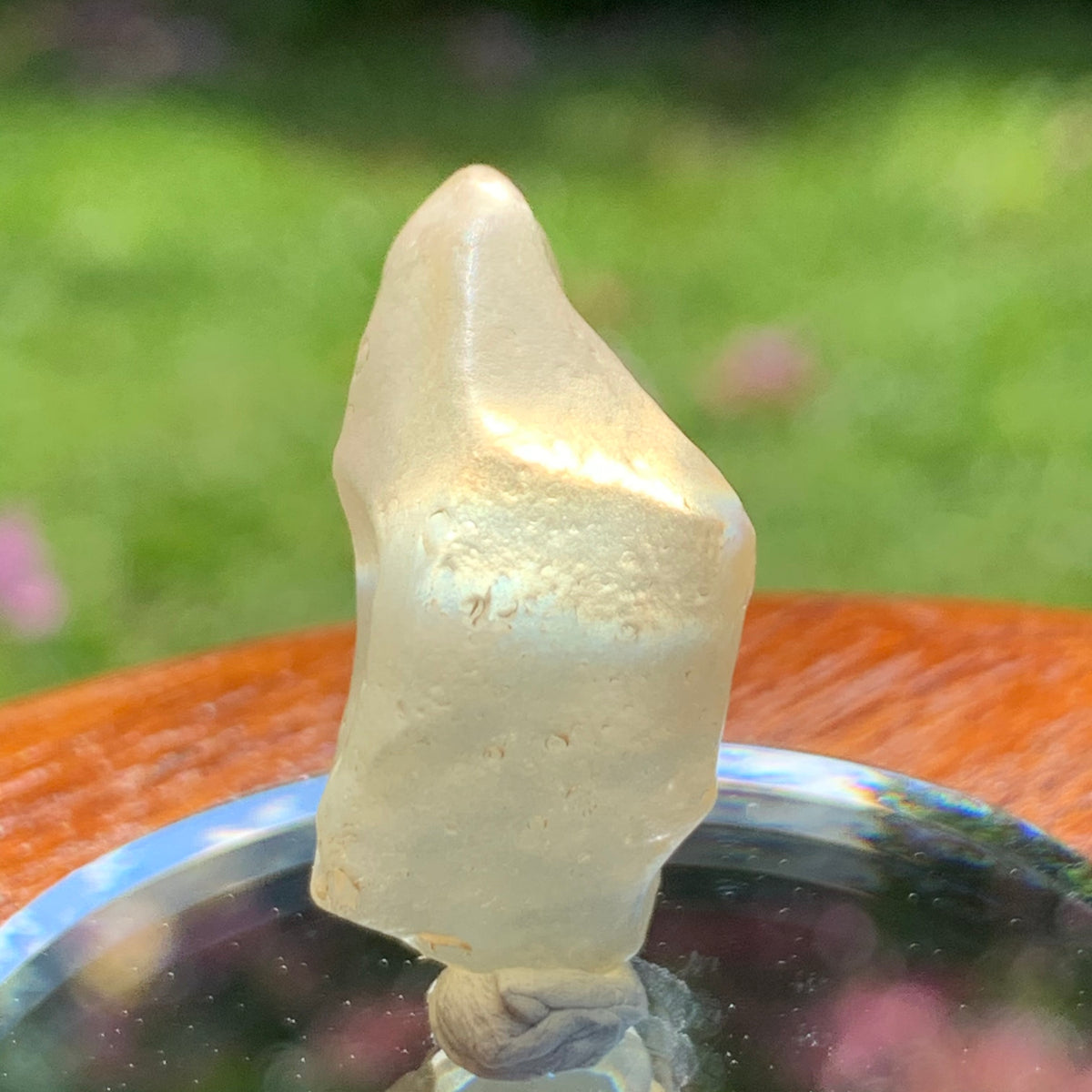 light reflects a rainbow through the libyan desert glass on display