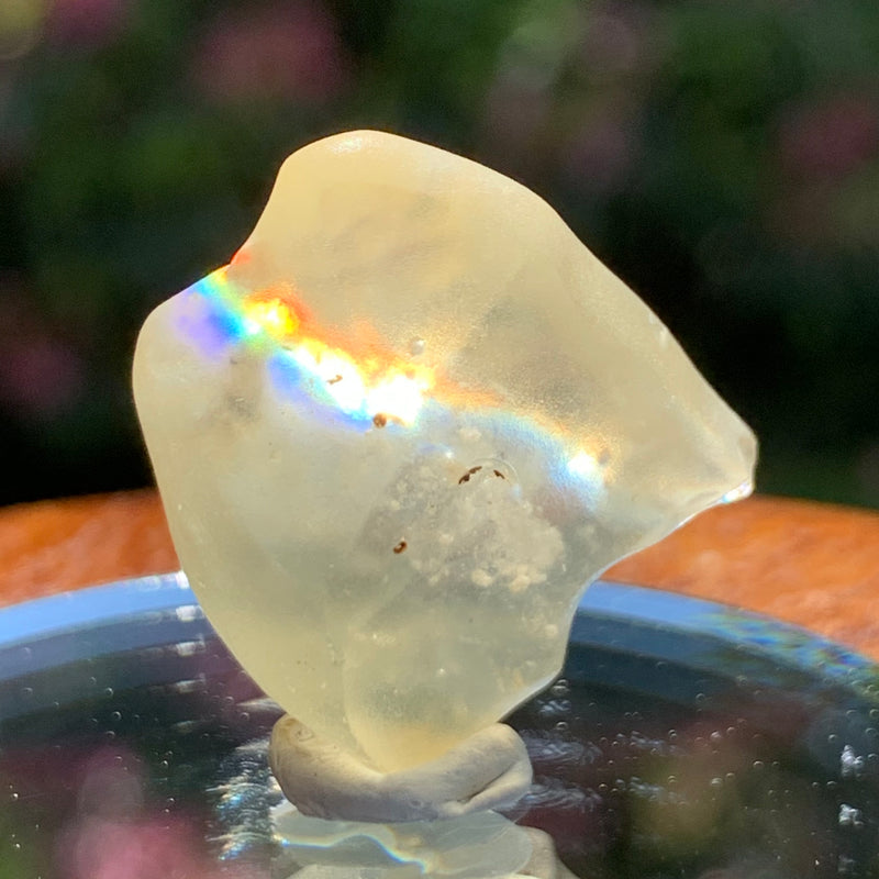 light reflects a rainbow through the libyan desert glass on display