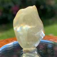 light reflects a rainbow through the libyan desert glass on display