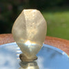 light reflects a rainbow through the libyan desert glass on display