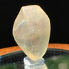 light reflects a rainbow through the libyan desert glass on display