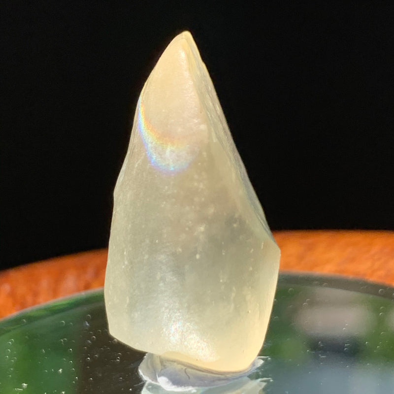 light reflects a rainbow on the libyan desert glass on display