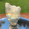 light reflects a rainbow through the libyan desert glass on display