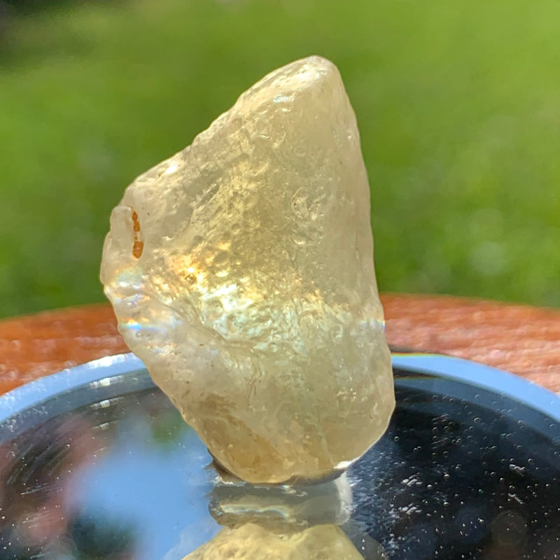 light reflects a gentle rainbow through the libyan desert glass on display