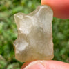 libyan desert glass is held up to show details with sunlight shining on it