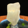 light reflects a rainbow through the libyan desert glass on display