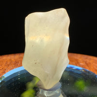 light reflects a rainbow through the libyan desert glass on display