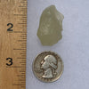 libyan desert glass next to a ruler and US quarter for scale