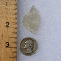 libyan desert glass next to a ruler and US quarter for scale