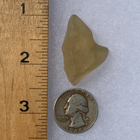 libyan desert glass next to a ruler and US quarter for scale