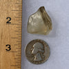 libyan desert glass next to a ruler and US quarter for scale