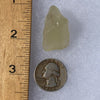 libyan desert glass next to a ruler and US quarter for scale