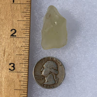 libyan desert glass next to a ruler and US quarter for scale