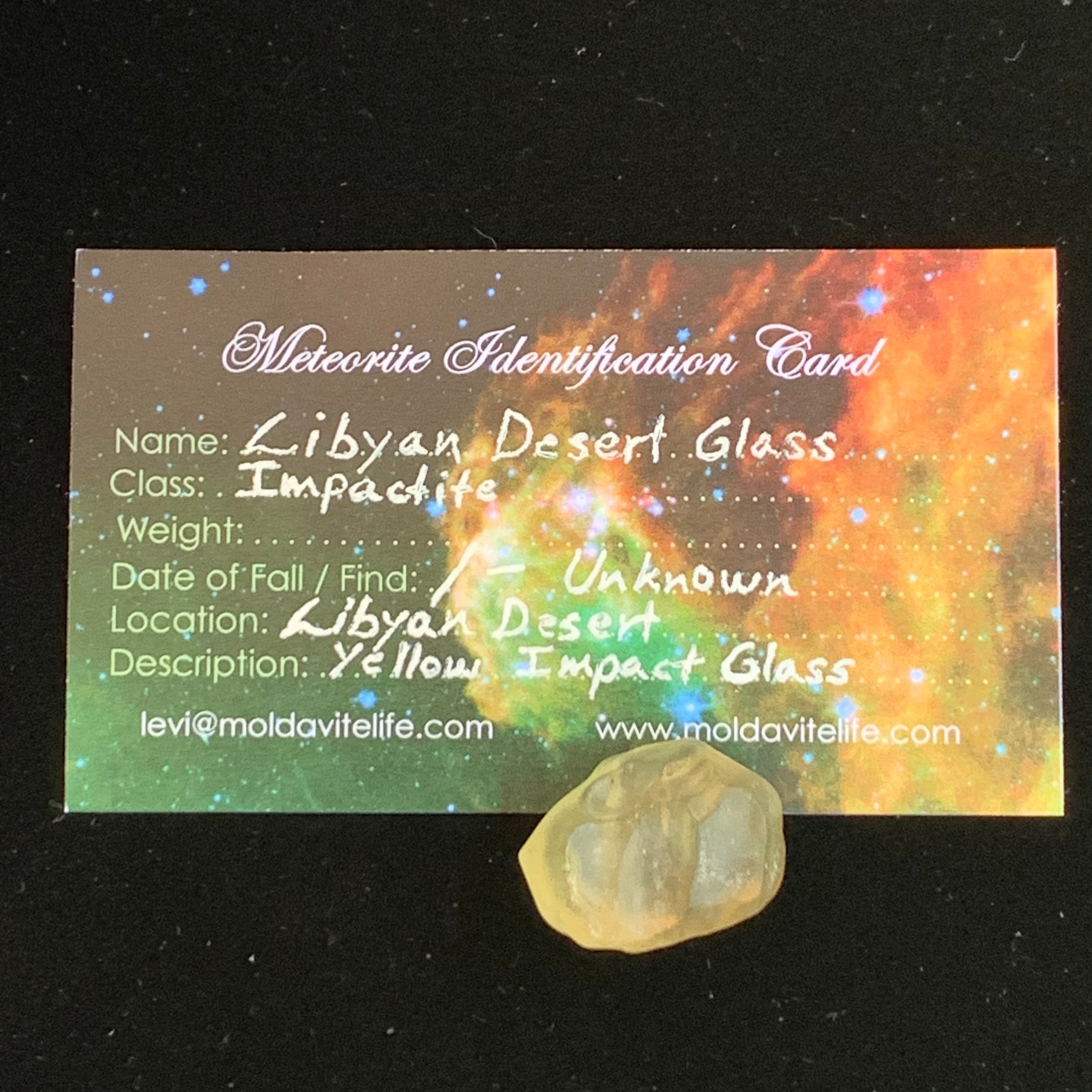 libyan desert glass sits with a moldavite life meteorite identification card