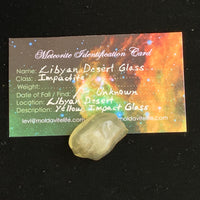 libyan desert glass sits with a moldavite life meteorite identification card
