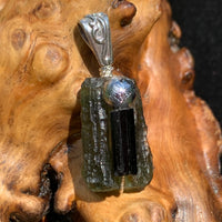the moldavite is wire wrapped with a black tourmaline and muonionalusta bead