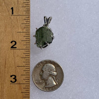 sterling silver moldavite tektite and herkimer diamond basket pendant next to a ruler and US quarter for scale