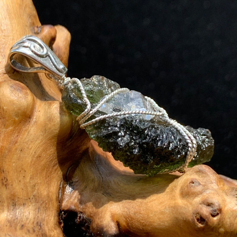 side view of moldavite wire wrapped with a herkimer diamond in sterling silver with a sterling bail