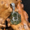 green moldavite and a clear herkimer diamond are wrapped in sterling wire with a sterling bail