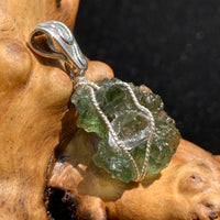 the pendant is seen from the side and the sterling wire is twisting around the stones