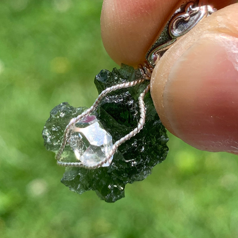 the herkimer diamond and silver wire glistens in the sun and the moldavite does too