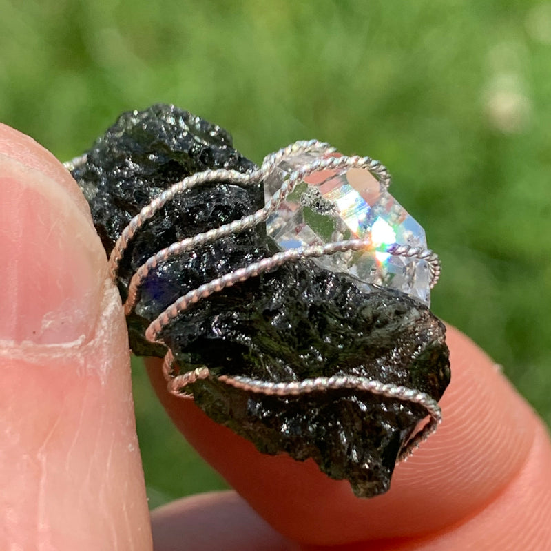 in the sun the moldavite looks dark and the herkimer diamond prisms