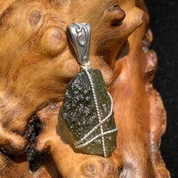 sterling silver is wire wrapped around a piece of moldavite in this lovely pendant