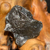 silver sikhote alin meteorite sitting on driftwood for display